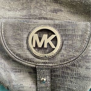 Michael Kors purse very stylish.   Beautiful color goes well with everything